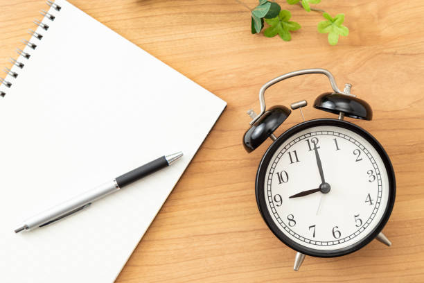 istock A notebook and an alarm clock on the desk. 1640311147