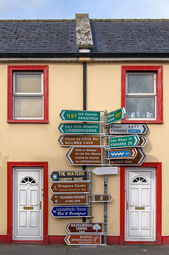 Road signs for directions and tourist spots in Ballyvaughan village, county Clare, Ireland.
