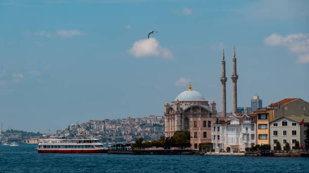 View of Ortaköy mosque in the Bosphorus and a flying seagull. The boats standing behind. Istanbul Türkiye View of Ortaköy mosque in the Bosphorus and a flying seagull. The boats standing behind. Istanbul Türkiye bogaz stock pictures, royalty-free photos & images