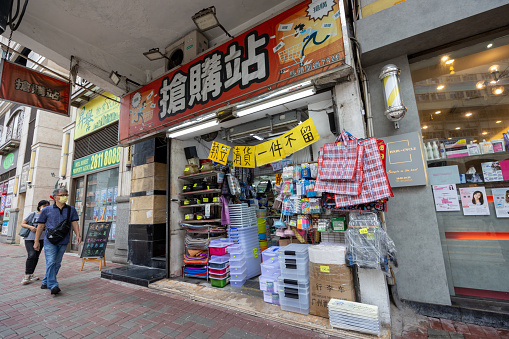 Hong Kong - August 26, 2023 : Pedestrians walk past a shop advertising its final sale before closing down in Kowloon, Hong Kong.