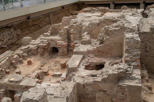 Underground Roman bath ruins next to a main street in Athens, Greece.
