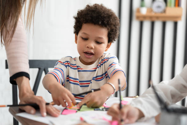 istock Happy African American kid boy studying with friend in classroom 1640338873