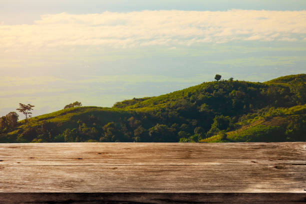 istock old wooden table and top mountain in background. 1640355734