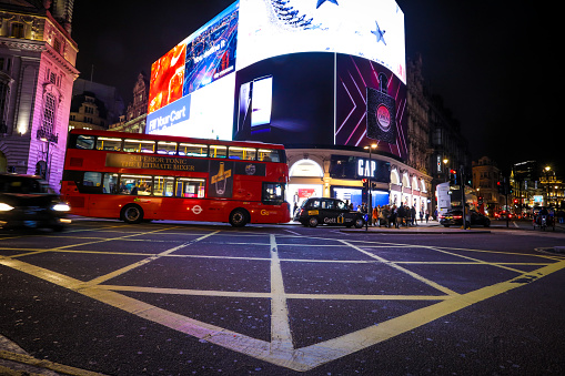 London, UK - 12 20 2017: London Piccadilly Circus night traffic. Piccadilly Circus is a major traffic junction in London and a busy meeting place and a tourist attraction.