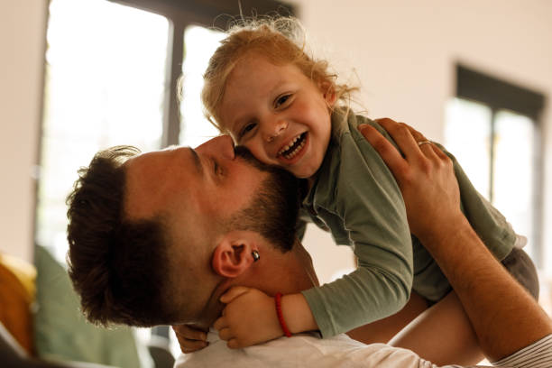 istock Cute little toddler laughing and having fun while playing with his father 1640381748