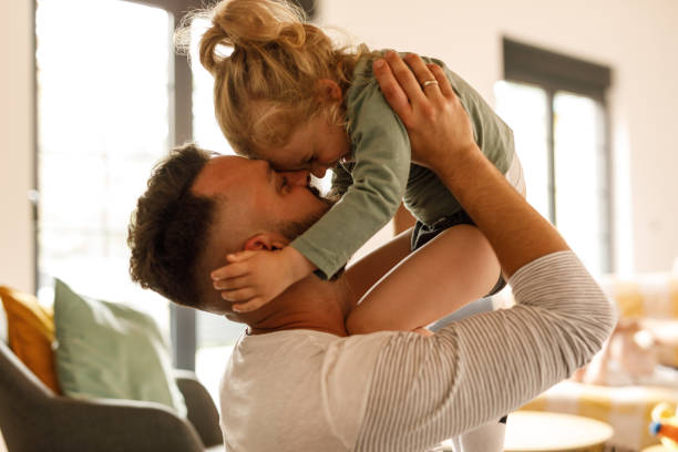 istock Cute little toddler laughing and having fun while playing with his father 1640381770