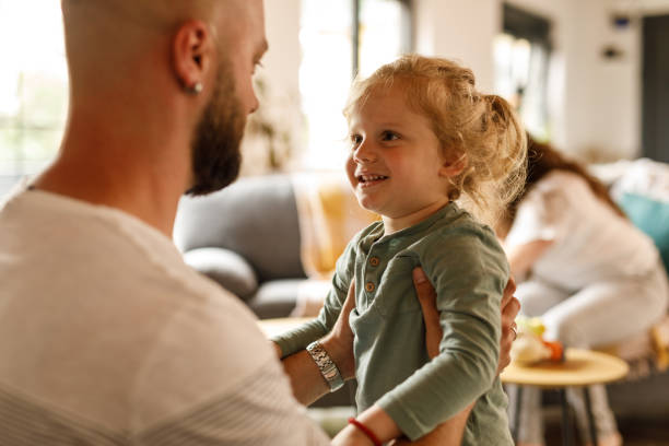 istock Cute little toddler laughing and having fun while playing with his father 1640381781