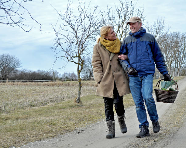 Loving couple walk arm in arm down the road