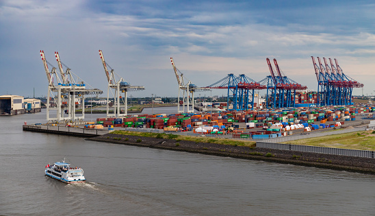 Hamburg, Germany - July 15, 2023, View from the water to the logistics center in Hamburg's industrial port. The gas holders can be seen in the background.