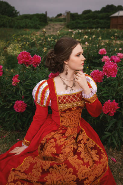 istock Medieval princess in peony garden 1640396695