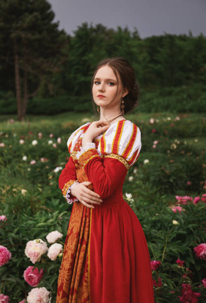 istock Medieval princess in peony garden 1640396697
