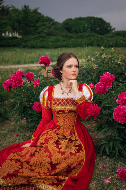 istock Medieval princess in peony garden 1640396700