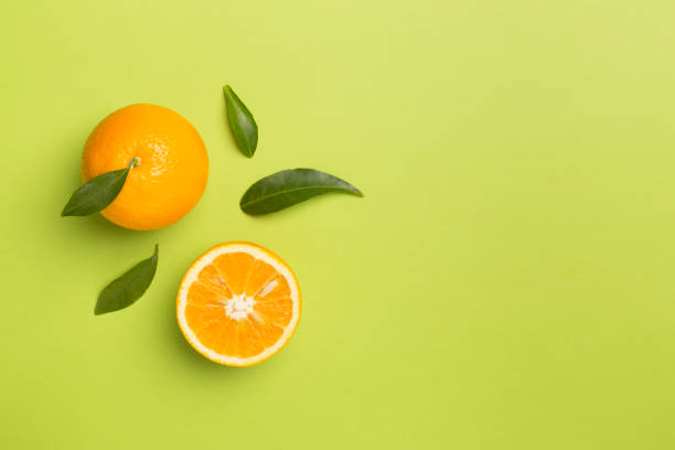 istock Flat lay with fresh oranges and leaves on color background 1640413641