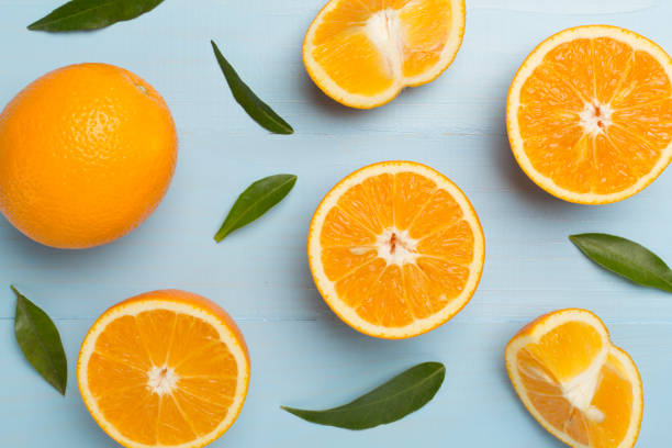 istock Flat lay with fresh oranges and leaves on wooden background 1640413931