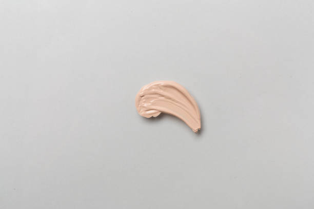 istock Foundation smudge on color background, top view 1640420262