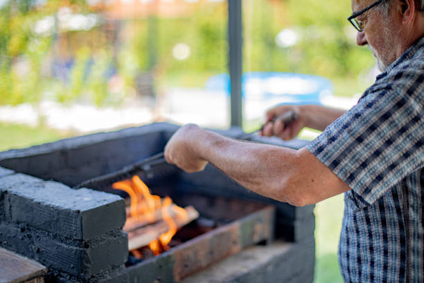 istock Senior man preparing barbeque in a backyard 1640424130