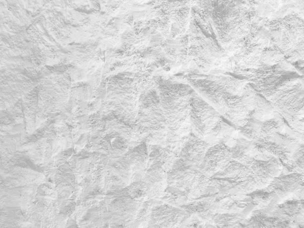 istock White wall surface of the white stone texture rough, gray tone. Use this for wallpaper or background image rock backdrop. There is a blank space for text. 1640434341