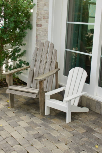 istock Regular and junior sized Adirondack chairs on the front porch 1640448880