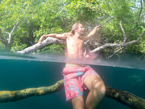 He explores the lake underground river, people on vacations, he adventures underwater