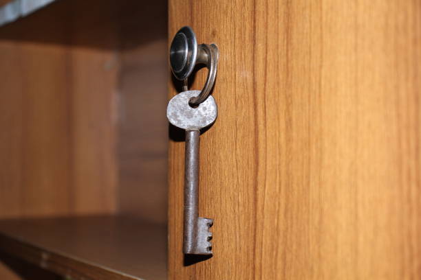 istock A key on a keyring with wooden background. 1640459258