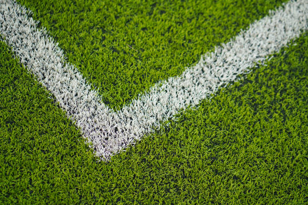 Football or soccer turf pitch ground with white corner line.