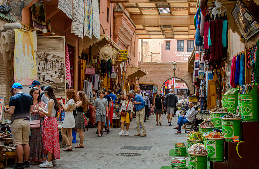 Athens - May 7, 2018: Old market near Monastiraki square in Athens, Greece. People visit stores and walk in bazaar outdoors in city center. Concept of shopping, travel and vacation in Athens.