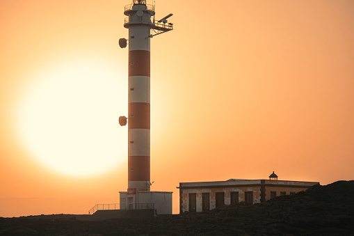 This lighthouse is in the south of Tenerife, I managed to capture the sun rising behind the lighthouse. Picture taken in Tenerife, Spain.