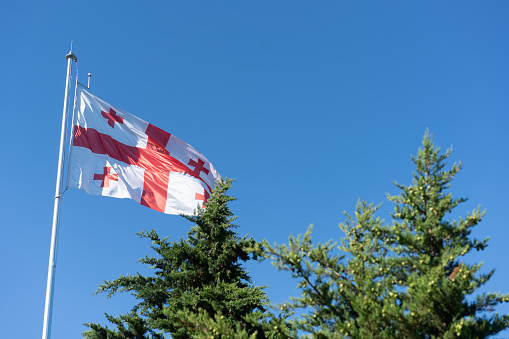 Georgian flag flutters in the wind on a sunny day