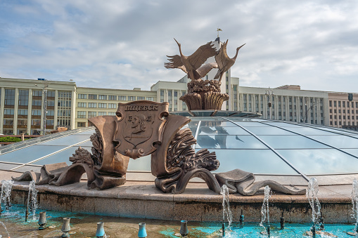 Minsk, Belarus - Jul 30, 2019: Fountain of Independence or Fountain of Three Storks with Vitebsk Coat of Arms at Independence Square - Minsk, Belarus