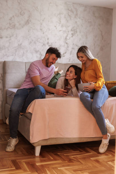 istock Friends watching funny memes on smart phone and snacking on popcorn 1640575695