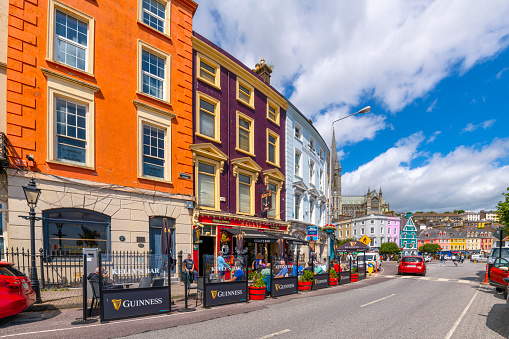 Colorful buildings with shops, pubs and cafes along the main seaside street of Cobh, Ireland,