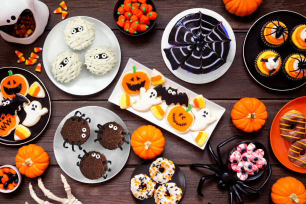 istock Spooky Halloween dessert table scene over a dark wood background 1640585724