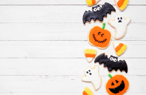 istock Halloween cookie side border on a white wood background 1640586178