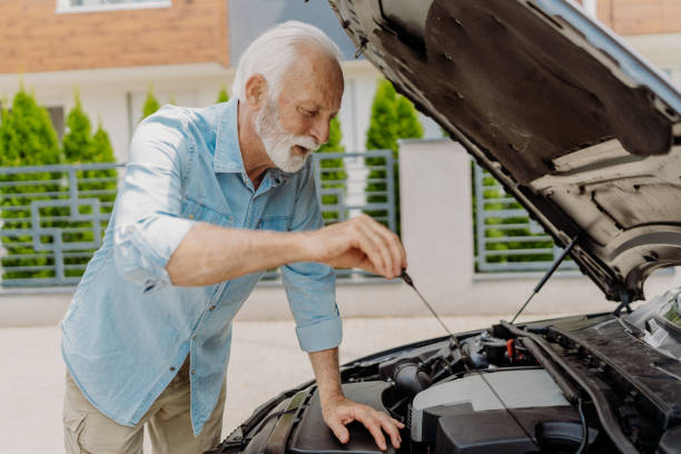 checking oil - old men car oil imagens e fotografias de stock