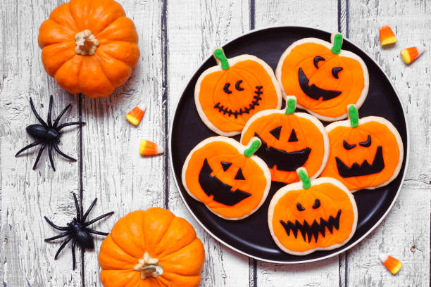 istock Halloween jack o lantern cookie table scene on white wood 1640588347