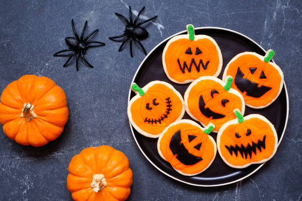 istock Halloween jack o lantern cookie table scene on a dark background 1640591006