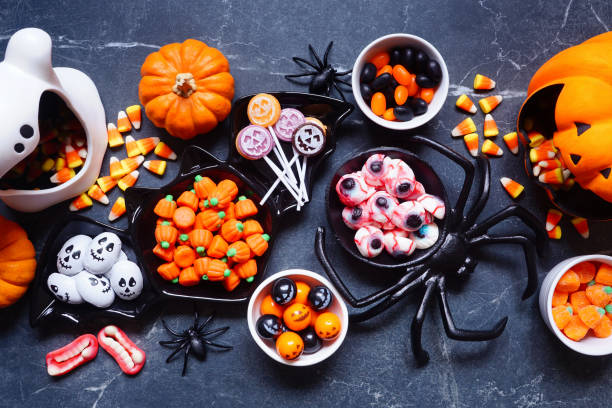istock Halloween trick or treat candy table scene on a dark stone background 1640591034