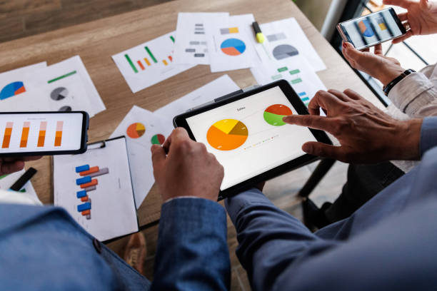 istock Businessman scrolling through various data on digital tablet during a meeting 1640591579