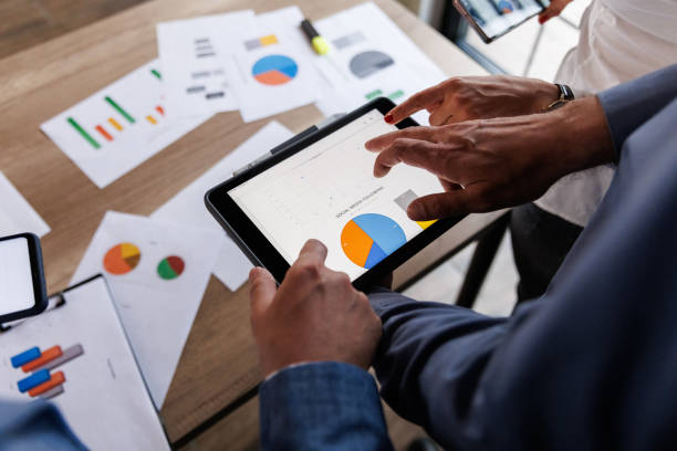 istock Businessman scrolling through various data on digital tablet during a meeting 1640591583