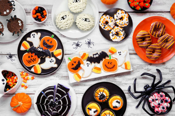 istock Spooky Halloween dessert table scene over a white wood background 1640594771