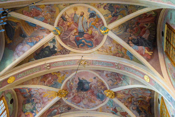 Reggio Emilia - The ceiling fresco of angels with the trumphs in church Chiesa di San Pietro by Anselmo Govi (1939).