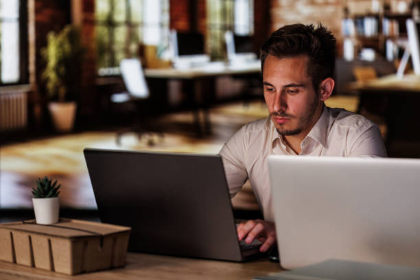 istock Diligent young man working at his desk in a modern office space 1640602258