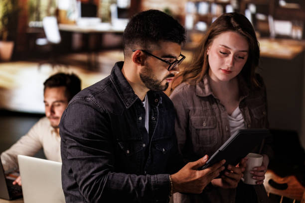 istock Two colleagues discussing data they are analyzing off of digital tablet 1640605384