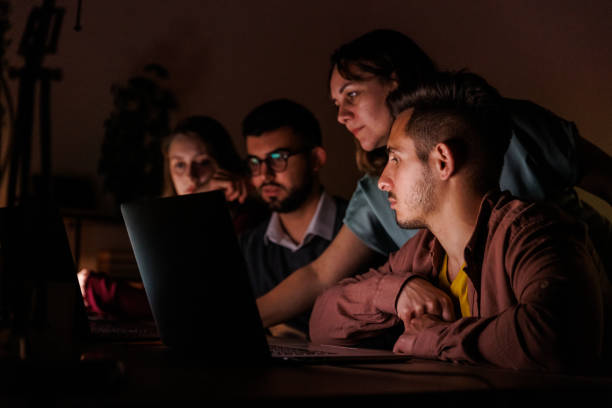 istock Group of entrepreneurs working as a team to finish a project late at night 1640606003