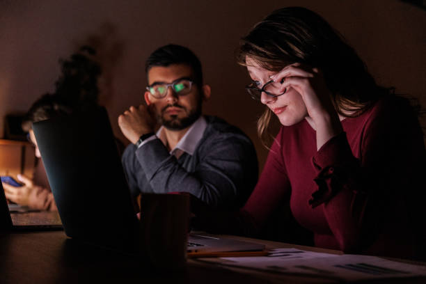 istock Two business people co-working on a project late at night 1640609217