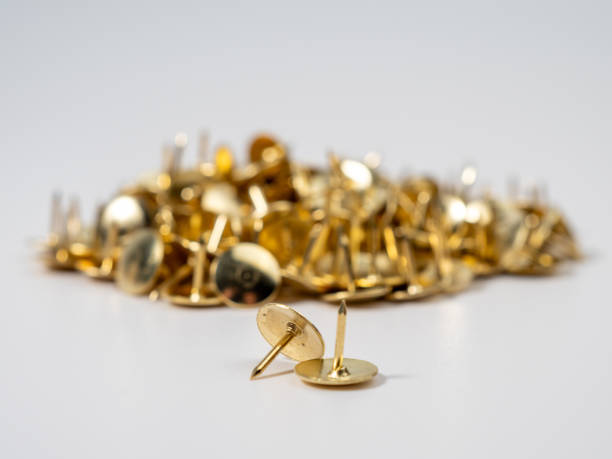istock Pushpins of gold color on a white background. 1640625062