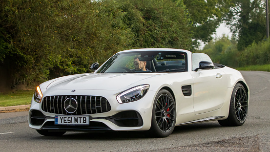 Whittlebury,Northants,UK -Aug 26th 2023: 2017 white Mercedes Benz AMG GT travelling on an English country road