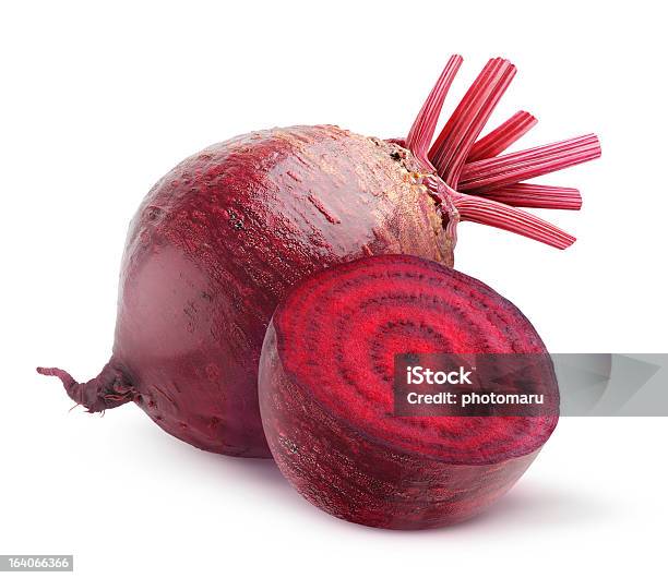 Whole Beetroot Next To One Cut In Half On A White Background Stock Photo - Download Image Now