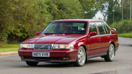 Whittlebury,Northants,UK -Aug 26th 2023:  1996 maroon Volvo 960 car travelling on an English country road