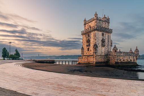 Torre de Belém next to the Tagus river, in a sunrise at low tide, Lisbon.